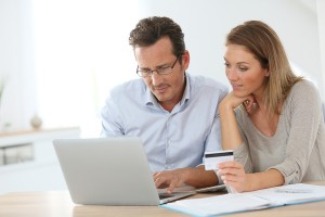 Couple connected with laptop and shopping online